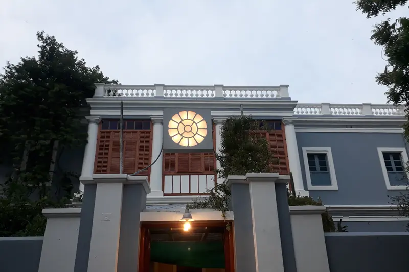 Grey and white colonial facade of the Sri Aurobindo Ashram main building