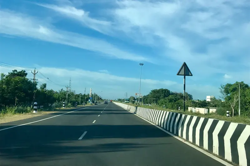 Open four-lane highway under a blue sky in Tamil Nadu